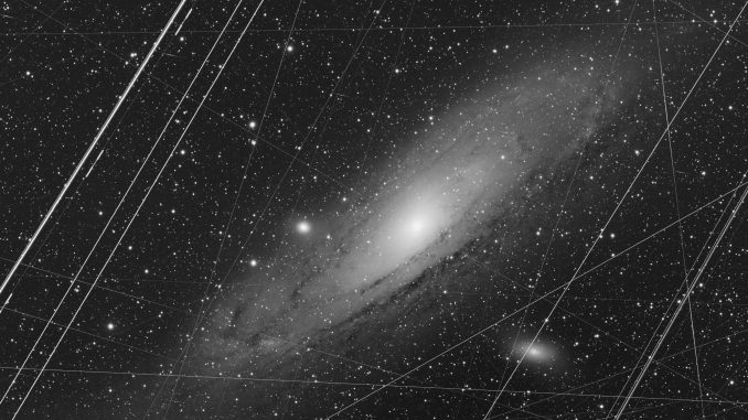 Andromeda before Photoshop  - </b><b> Explanation: </b> What does the Andromeda galaxy really look like? The <a href="https://www.flickr.com/photos/kees-scherer/48847775697/">featured image</a> shows how our <a href="https://solarsystem.nasa.gov/resources/285/the-milky-way-galaxy/">Milky Way Galaxy</a>'s closest major galactic neighbor really appears in a long exposure through <a href="https://solarsystem.nasa.gov/planets/earth/overview/">Earth</a>'s busy skies and with a digital camera that introduces normal imperfections. The picture is a stack of 223 images, each a 300 second exposure, taken from a garden observatory in <a href="https://en.wikipedia.org/wiki/Portugal">Portugal</a> over the past year. Obvious image deficiencies include bright parallel <a href="https://apod.nasa.gov/apod/ap070825.html">airplane trails</a>, long and continuous <a href="https://apod.nasa.gov/apod/ap080604.html">satellite trails</a>, short <a href="https://www.eso.org/~ohainaut/ccd/CCD_artifacts.html">cosmic ray streaks</a>, and <a href="https://www.astro.rug.nl/~ndouglas/teaching/JAFFE/reduce.htm#BAD%20PIXELS">bad pixels</a>. These imperfections were actually not removed with <a href="https://en.wikipedia.org/wiki/Adobe_Photoshop">Photoshop</a> specifically, but rather <a href="https://apod.nasa.gov/apod/image/1910/AndromedaAfter_Scherer_960.jpg">greatly reduced</a> with a series of computer software packages that included Astro Pixel Processor, DeepSkyStacker, and PixInsight. All of this work was done not to <a href="https://tenor.com/view/confused-dog-who-me-gif-14663746">deceive you</a> with a <a href="https://apod.nasa.gov/apod/ap131230.html">digital fantasy</a> that has little to do with the real likeness of the <a href="https://apod.nasa.gov/apod/ap181217.html">Andromeda galaxy</a> (M31), but to minimize Earthly artifacts that have nothing to do with the distant galaxy and so better recreate <a href="https://apod.nasa.gov/apod/ap190909.html">what M31 really does look like</a>. <b>Image Credit: </b> <a href="https://www.flickr.com/people/kees-scherer/">Kees Scherer