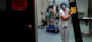 Un paramedico posiziona una lampada germicida a raggi ultravioletti C (UVC) per disinfettare una stanza dell'ospedale di Fuenlabrada, vicino a Madrid (ansa)