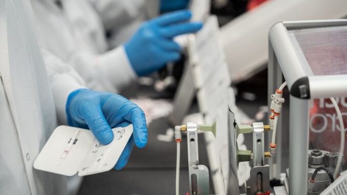 Workers assembling at-home Covid-19 test kits last year at the Abbott Laboratories facility in Gurnee, Ill.  Photo: Sebastian Hidalgo for The Wall Street Journal